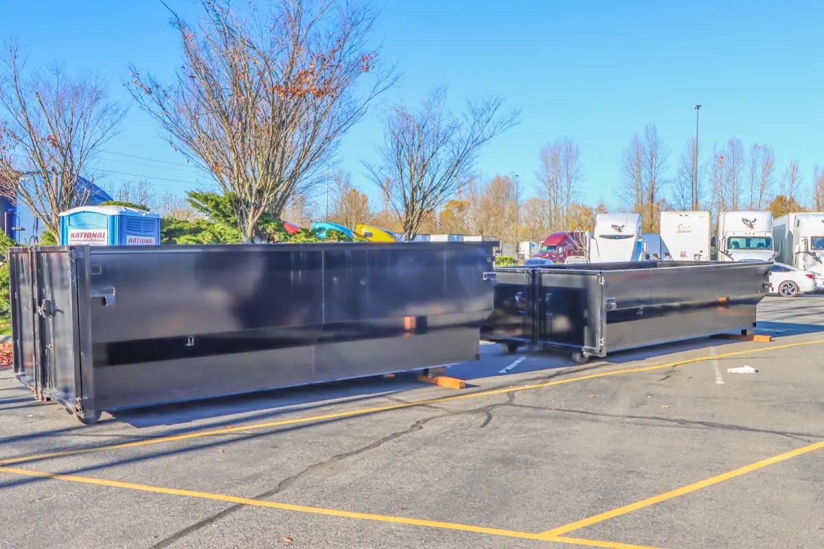 Professional dumpster rental service with roll-off container on residential driveway in Chestnut Ridge